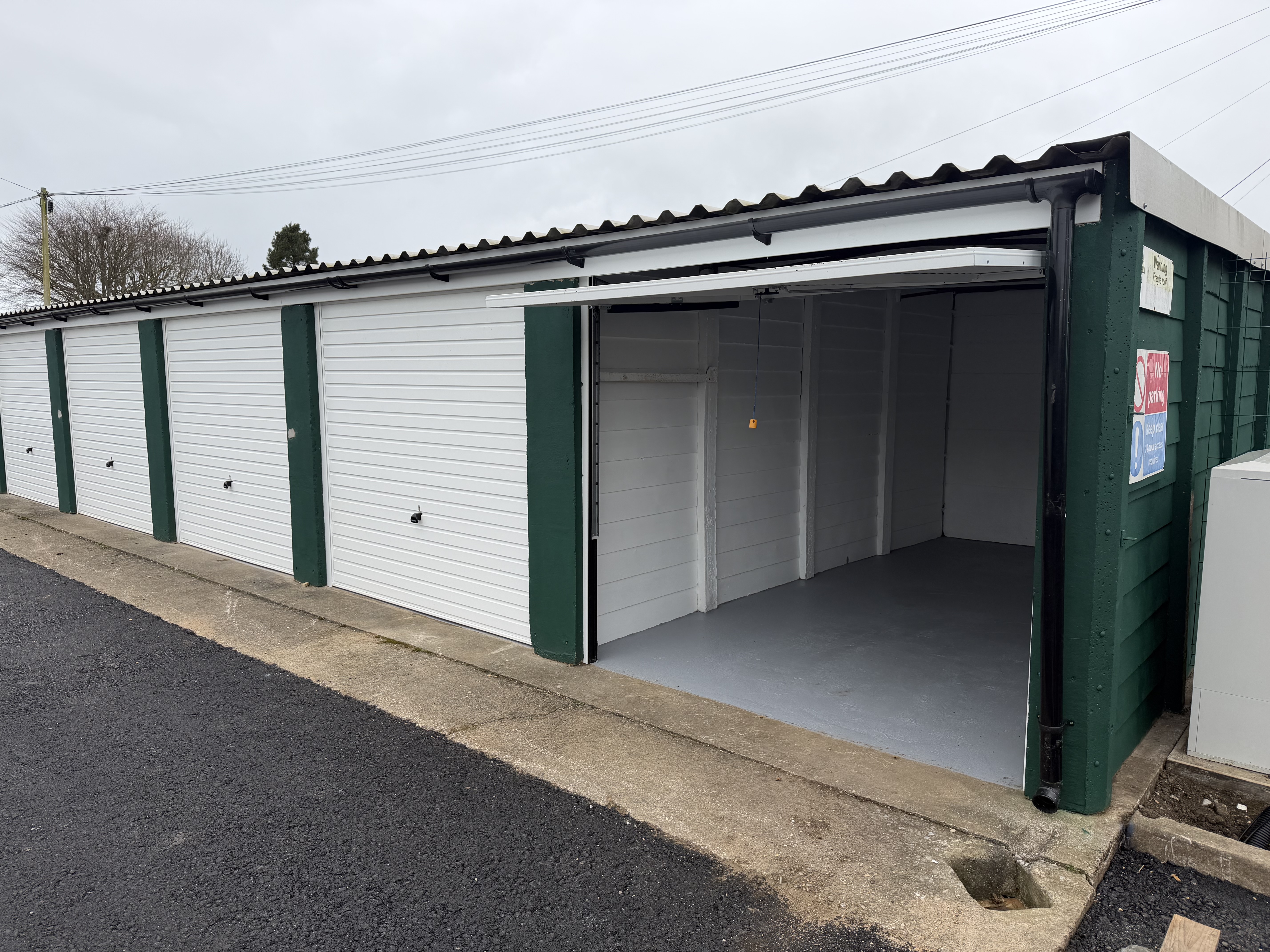 Open double garage interior at The Storage Containers Sherborne lock-up site, Wingfield Road, DT9 3HH — freshly refurbished with new white roller doors